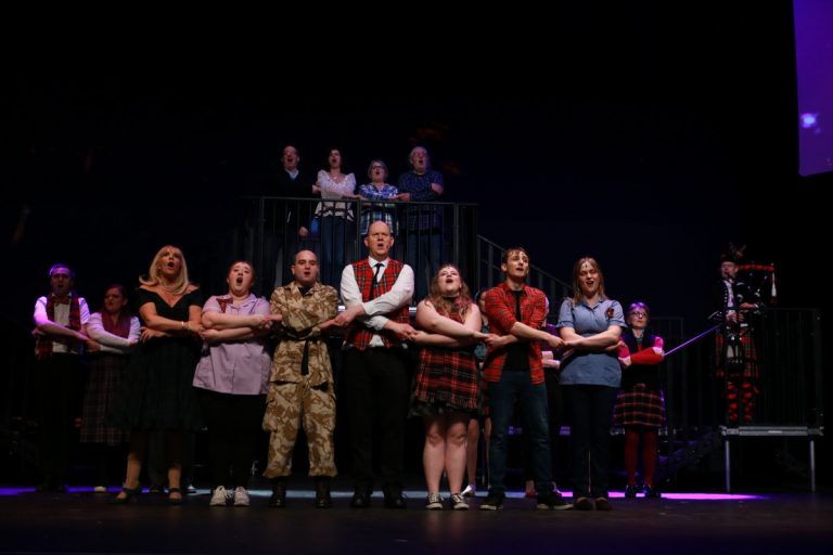 Members of Shrewsbury Musical Theatre Company performing Sunshine on Leith