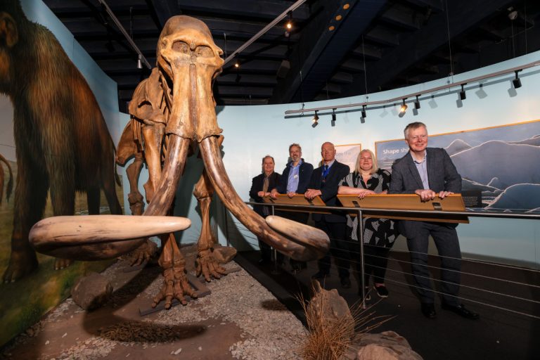 In the exhibition with the well-known replica skeleton of the fully grown male mammoth that was found less than 20 miles away. Cllr David Evans (left), Grant Wilson, Cllr David Mills, Tammy Shurmer and Richard Woolley (right).