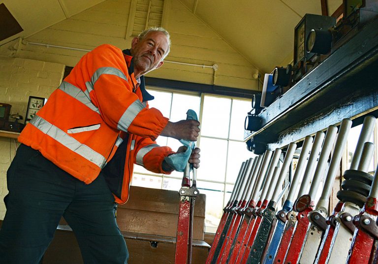 CHR General Manager Andy Green operating the signals at Oswestry as services resume