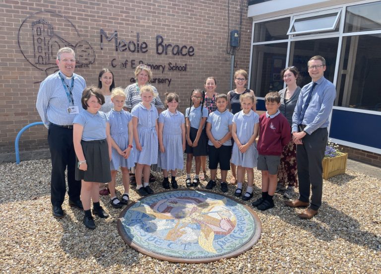 Staff and pupils from Meole Brace C of E Primary and Nursery and Shrewsbury School unveil the new mosaic