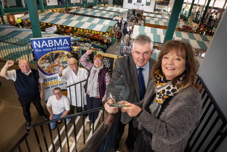 Market Hall Facilities Manager Kate Gittins receiving a Lifetime Achievement Award from NABMA Chief Executive David Preston alongside some of the market’s longest serving traders Jon Corbett of Corbett’s Butchers, Ian Cornall of Cornall’s Seafoods, Mel Ling of Cook & Carve delicatessen and Angela Butler of The Card Stall