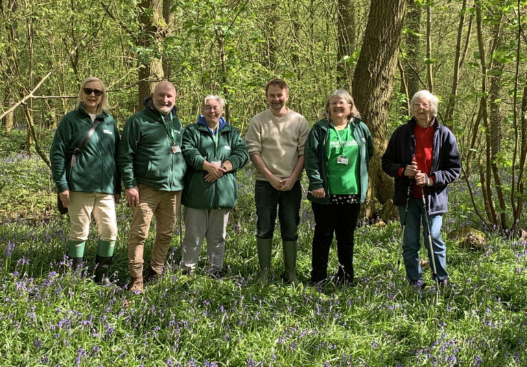 Members of Shrewsbury Macmillan Cancer Support Fundraising Group with Tim Ashton from Soulton Hall in the bluebell wood.
