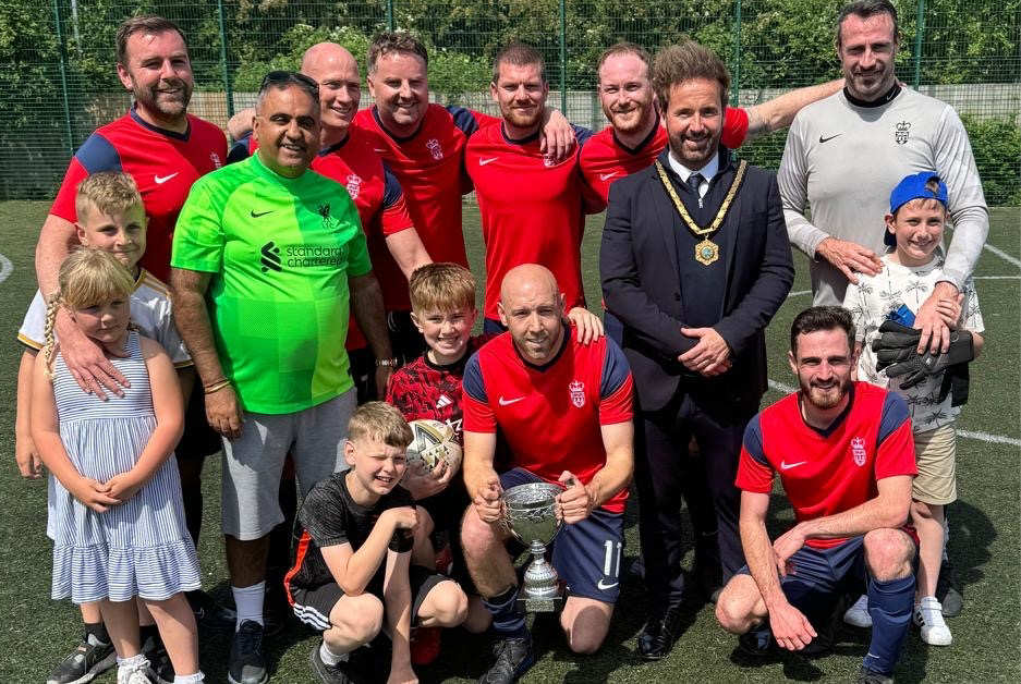 Tournament winners West Mercia Police with family members and Councillor Raj Mehta (Lab), Cabinet Member for Inclusion, Engagement, Equalities & Civic Pride, pictured in green, and Councillor Ian Preece (Lab), Deputy Mayor of the Borough of Telford and Wrekin and Director of AFC Telford Utd Foundation. Photo: Telford & Wrekin Council.