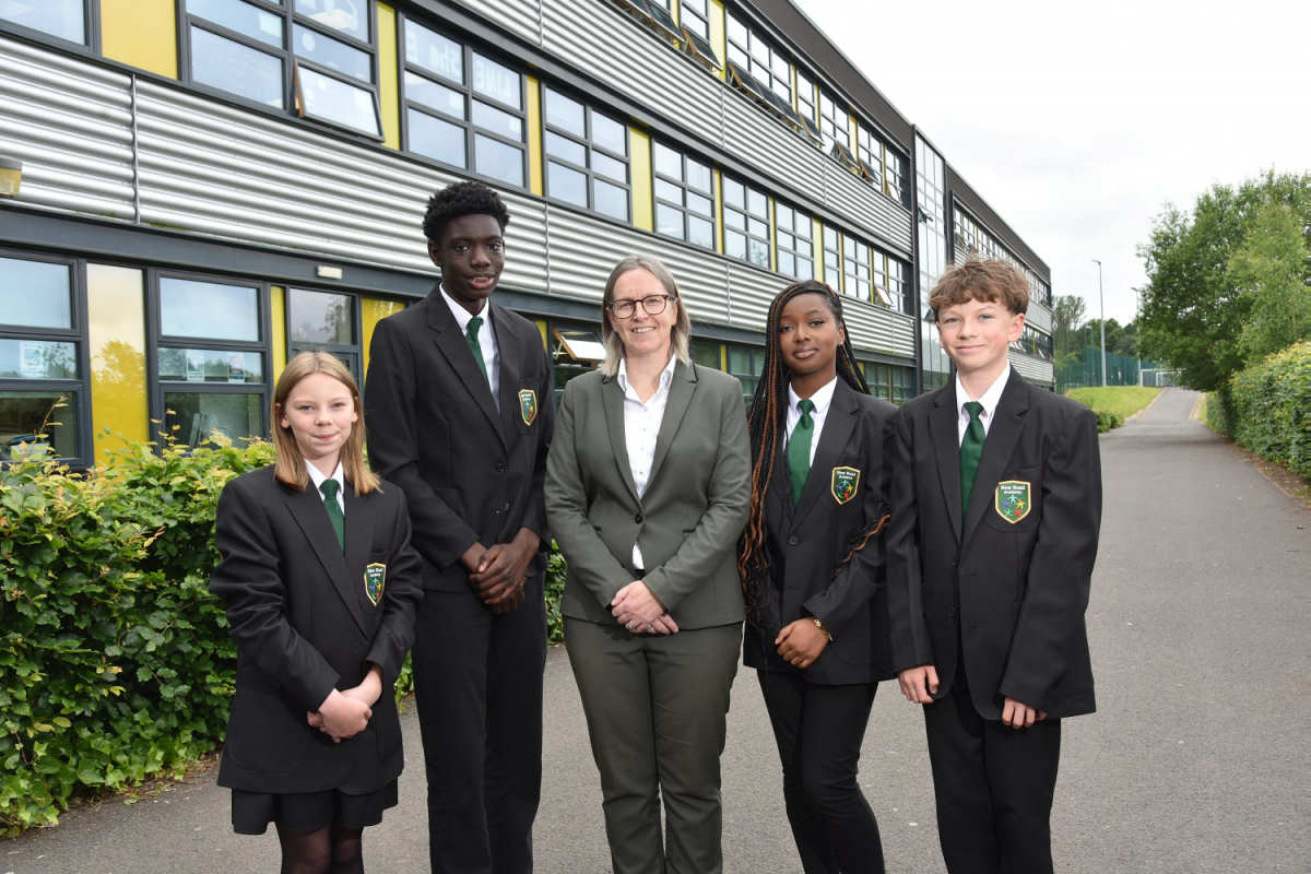 New head teacher Andrea Bell with students in the academy’s new uniform, from left, Jessica Ramsay, Omar Mbye, Stacey Karikari and Daniel Wright.