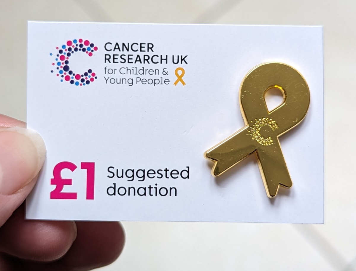 Cancer Research UK gold ribbon badge