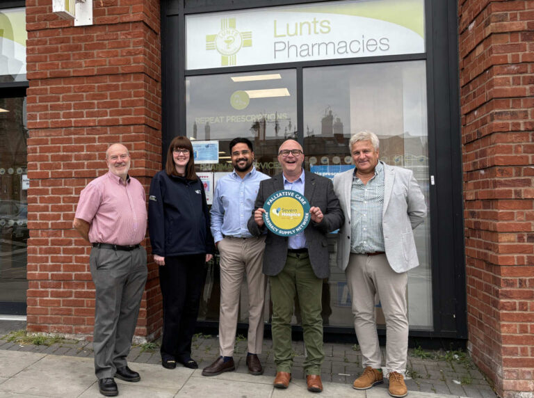 Representatives from Lunts Pharmacy (The Tannery), the NHS, Community Pharmacy Shropshire, and Severn Hospice display a window sticker that the network pharmacies use to indicate they stock palliative care medicines