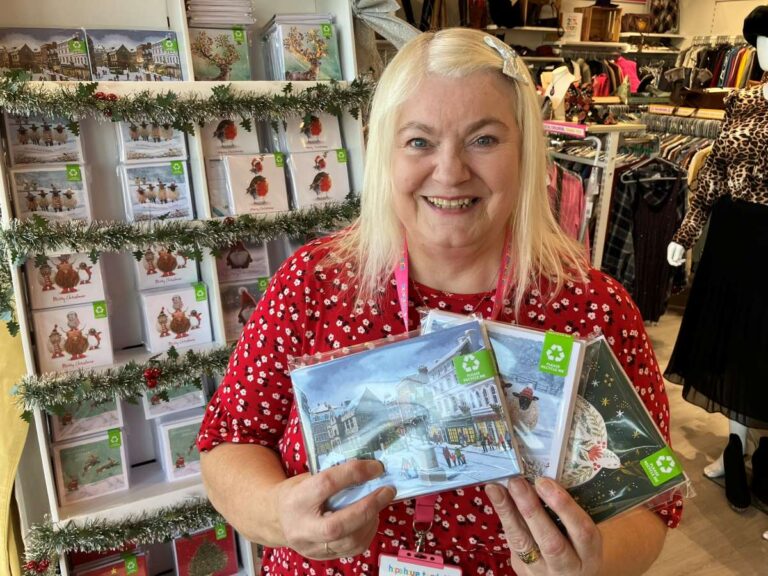 Volunteer Debbie Colton with some of the Christmas cards available
