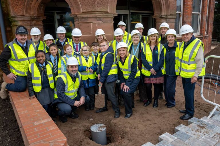 Local school children join partners to help bury the time capsule