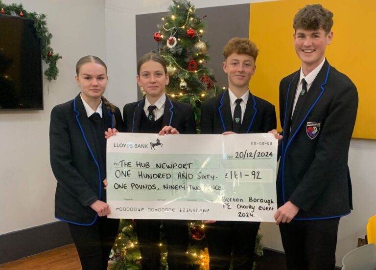 Burton Borough School students handing over cash to The Hub, Ava Summer Williams, Holly Appleby, Harvey Arnold and Max Harris