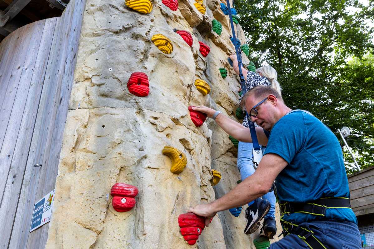 Councillor Paul Davis, Telford & Wrekin Council Cabinet Member for Communities and Civic Pride and Tracey Onslow, West Mercia Assistant Police and Crime Commissioner, trying out the climbing wall at Telford Aerial Adventure, one of the activities on offer over October half-term