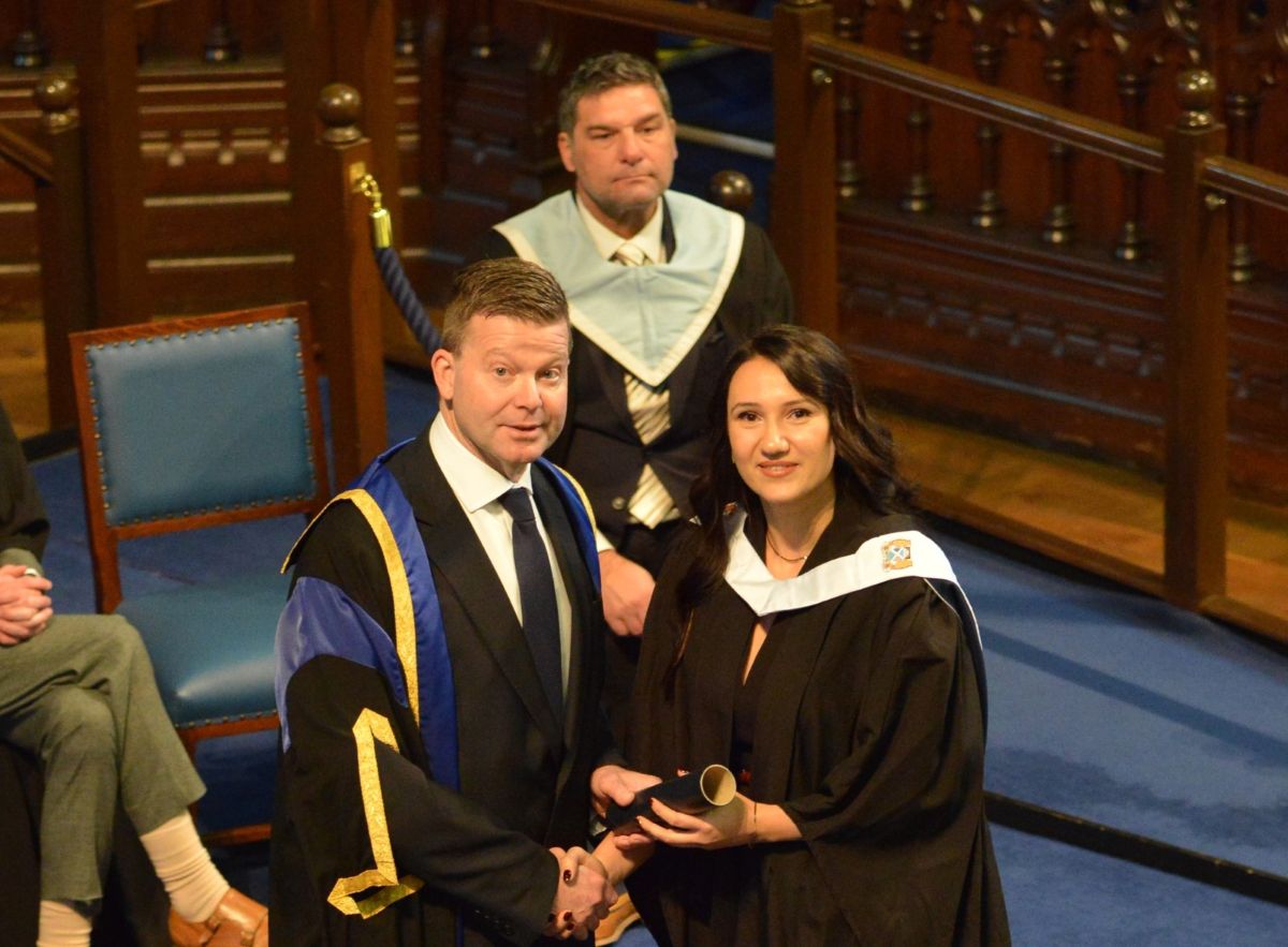 Eliz Chausheva collecting her degree-level diploma