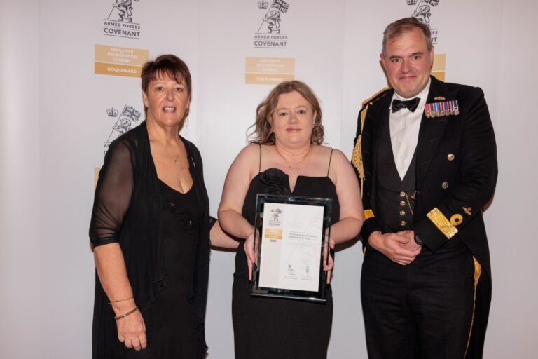 Commodore Tristram Kirkwood presents Sarah Millington and Lisa Walker with the Gold award