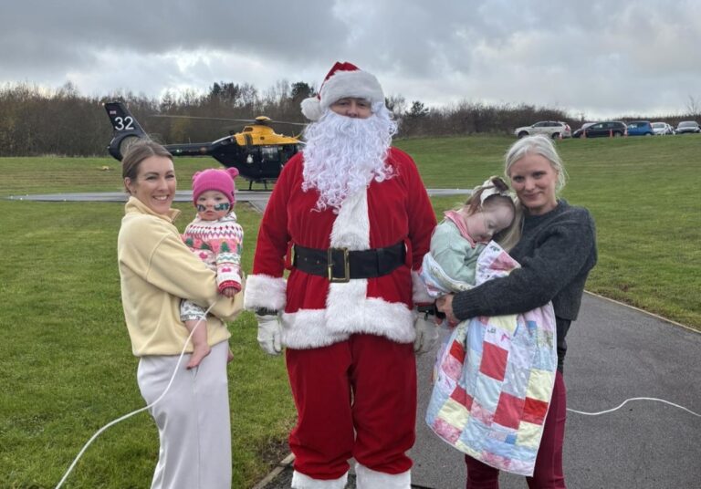 Jo Mitchell Smith with daughter Willow, aged 16 months,and Emma Hughes with Myla, aged two, greet Santa