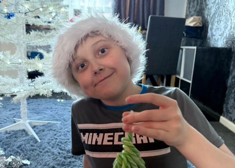 Lucas decorating a Christmas tree this year after receicing a liver transplant