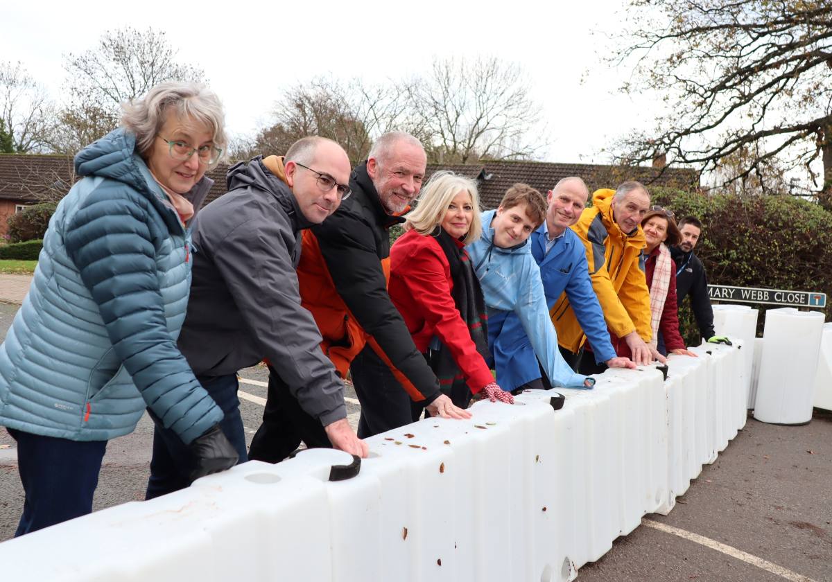 Members of Shropshire Rural Housing and local residents with the new flood barriers