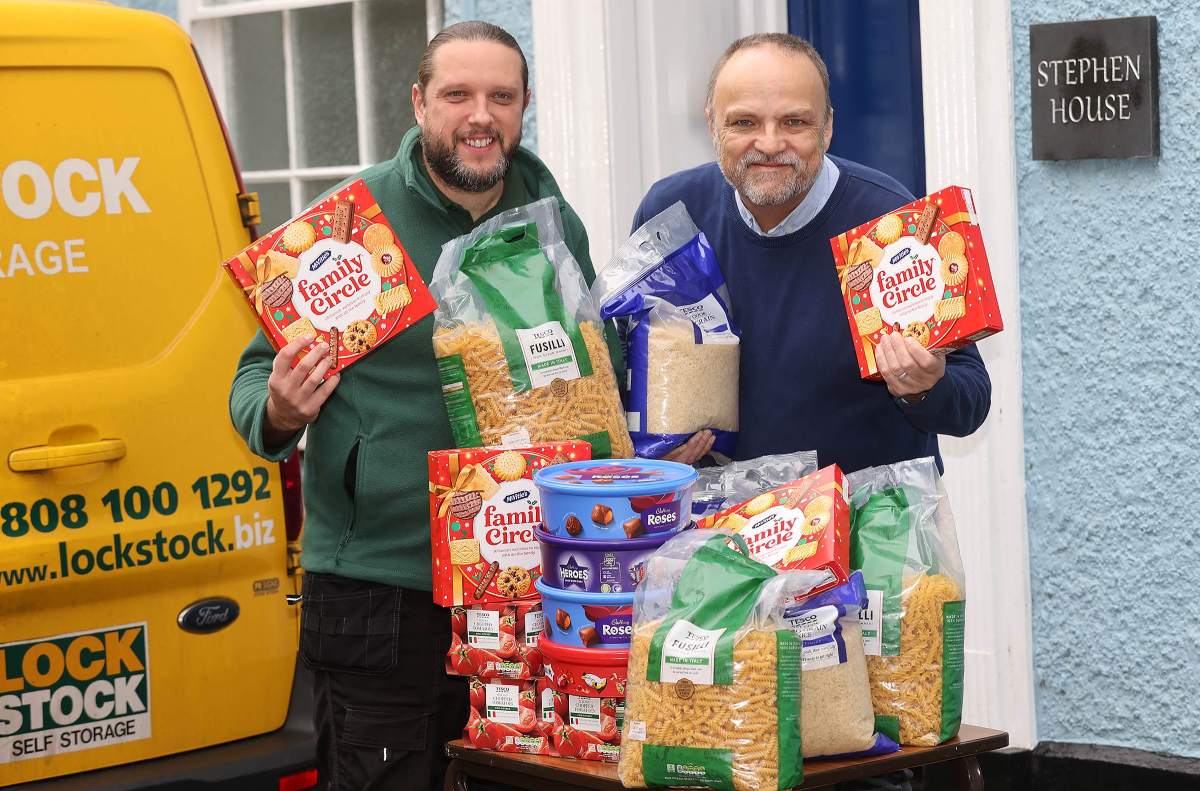 Lock Stock Self Storage Area Manager Alan Brightmore handing over Christmas goodies to Paul Kemp at Ludlow’s Stephen House, the St Laurence’s Church town centre hub that helps vulnerable people