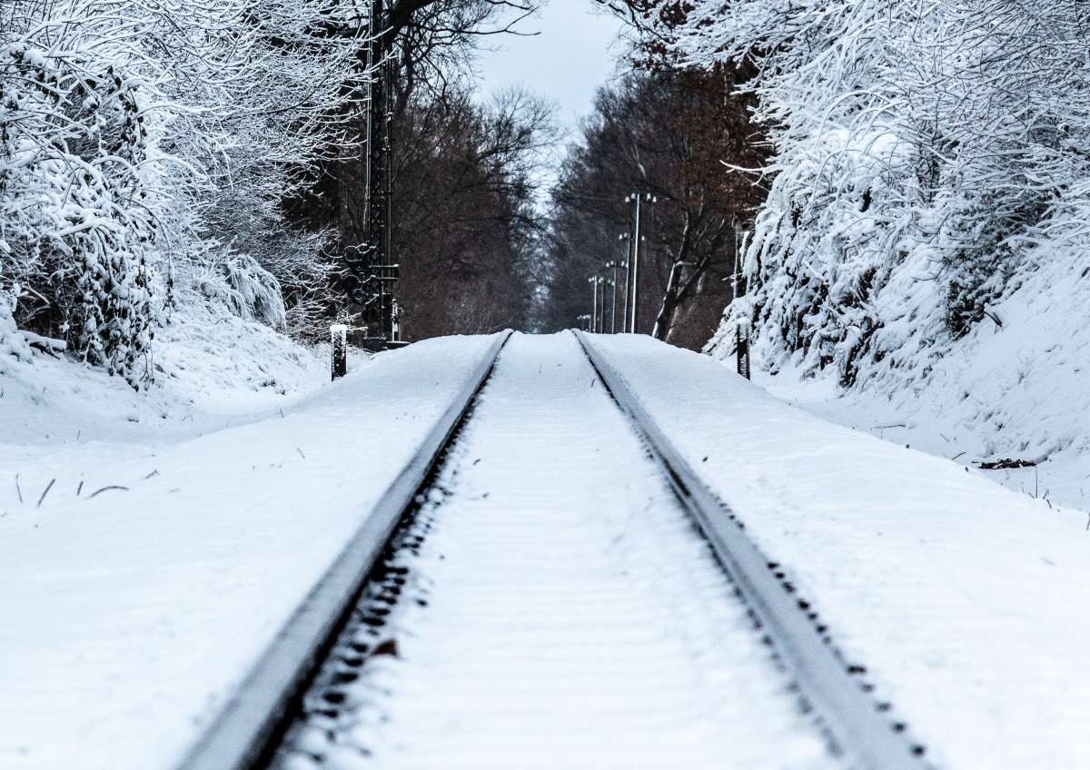 A generic photo of a train track in the snow