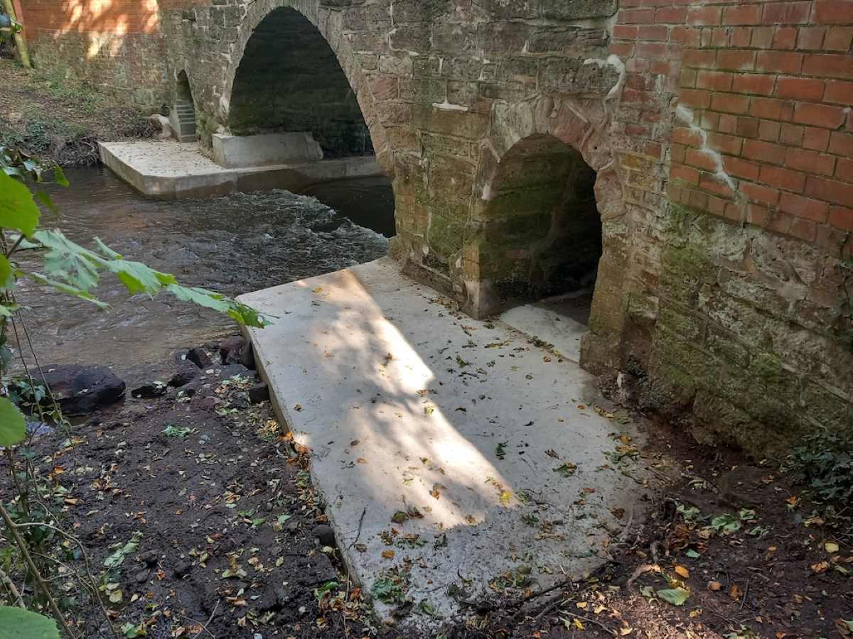 Defective concrete aprons supporting the bridge were removed and replaced to protect its stability and longevity