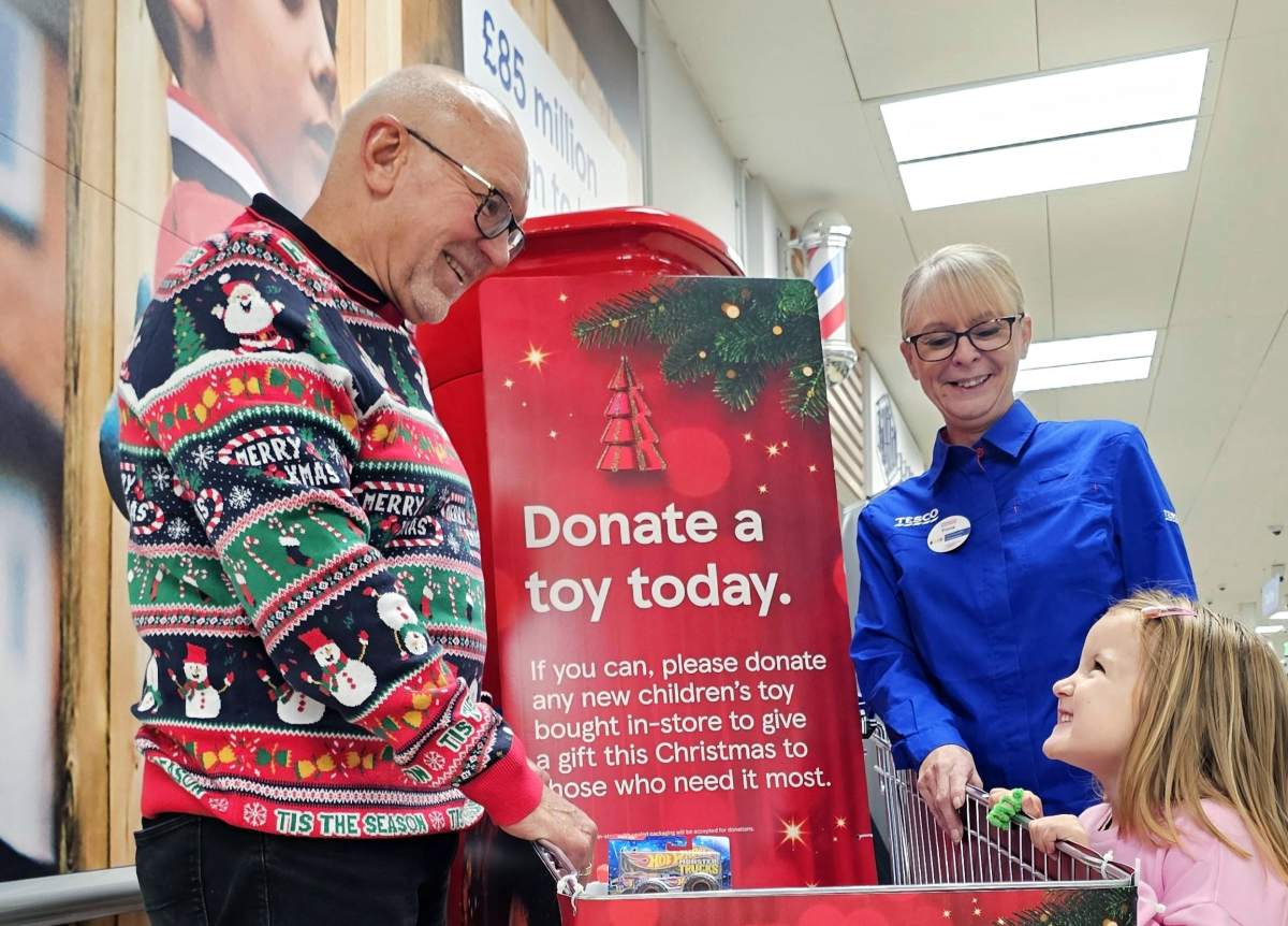 Grandad, grandaughter and community champion at a donation point